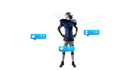 Posing football player wearing silver helmet and blue jersey in studio, with notification icons