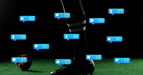 Balancing player's foot standing on turf, with socks, cleats, red-black soccer ball and blue icons