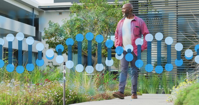 Strolling man in red jacket and trousers along courtyard walkway with DNA helix overlay, copy space - Powered by Adobe