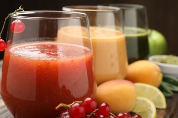 Superfood. Tasty smoothies in glasses and ingredients on table, closeup