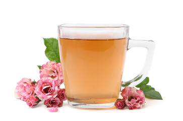 Tasty rose tea in glass cup and flowers isolated on white