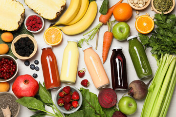 Superfood. Bottles with healthy drinks and ingredients on light wooden table, flat lay