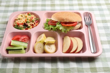 Plastic tray with tasty food and fork on table, closeup. School lunch