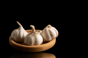 Garlic heads isolated on white and black background, close-up.