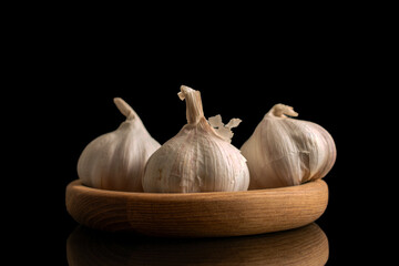 Garlic heads isolated on white and black background, close-up.