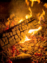 a log on fire in the firepit