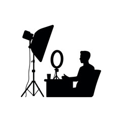Silhouette of person sitting at desk with ring light and studio light vector