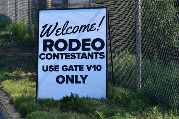 "Welcome! Rodeo Contestants, use gate V10 only" printed on sign.