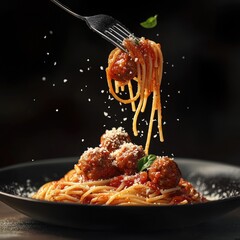 Forkful of spaghetti and meatballs, a dish of pasta with meatball,  in a dark setting