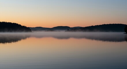Fototapeta premium scene of a calm body of water reflecting a subtle, hopeful sunrise on New Year's Day. Distant, silhouetted trees or mountains line the horizon, adding depth. The water is perfectly still,