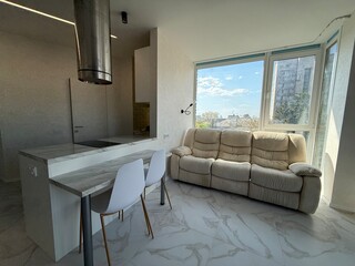 Modern Studio Kitchen and Living Area with Large Windows