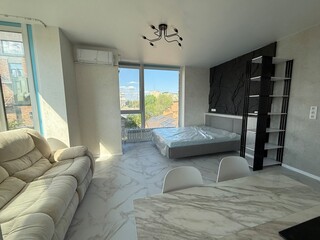 Sunny Studio Apartment with Panoramic Windows and Modern Interior