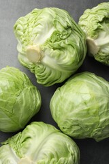 Fresh green cabbages on grey table, flat lay