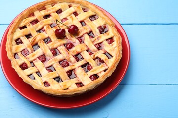 Tasty cherry pie on light blue wooden table, closeup