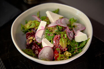 A Colorful Salad Featuring Fresh Greens, Radishes, Feta Cheese, and Quinoa for a Nutritious and Delicious Meal Experience