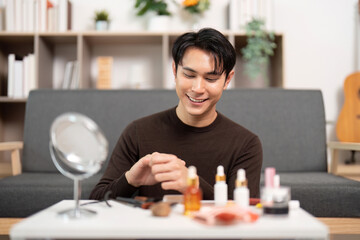 Makeup Routine. Young man enjoying his beauty regimen while seated comfortably.