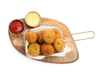 Delicious fried croquette balls with parsley and sauces isolated on white, top view