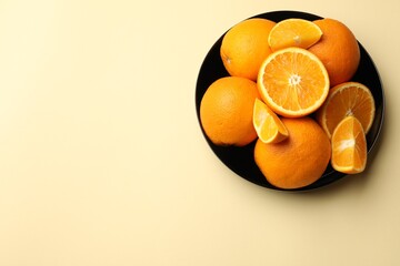 Fresh ripe oranges on beige background, top view. Space for text