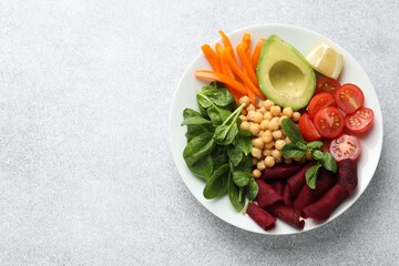 Different healthy vegetarian food on light grey table, top view. Space for text