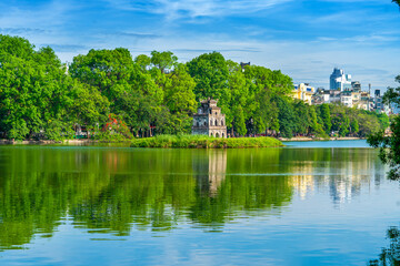 View of Turtle Tower at Hoan Kiem Lake in spring with beautiful reflection, an important historical building in Hanoi, Vietnam