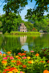 View of Turtle Tower at Hoan Kiem Lake in spring with beautiful reflection, an important historical...