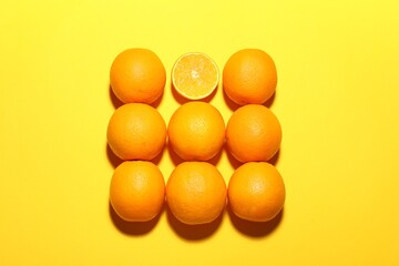 Fresh ripe oranges on yellow background, flat lay