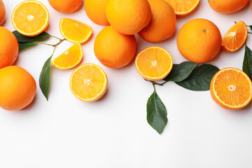Fresh ripe oranges and green leaves on white background, flat lay. Space for text