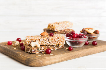 Various granola bars on table background. Cereal granola bars. Superfood breakfast bars with oats,...