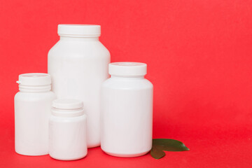 supplement pills with medicine bottle health care and medical top view. Vitamin tablets. Top view mockup bottle for pills and vitamins with green leaves, natural organic bio supplement, copy space