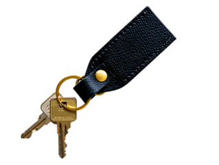 Close up of a black leather keychain with brass ring and house keys isolated on transparent background