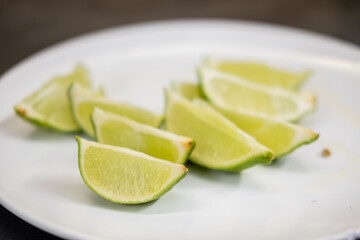 Lime slice, served on white plate for drink and cocktail