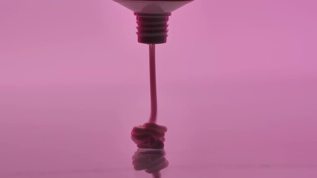 Creative close-up of cream on a pink background