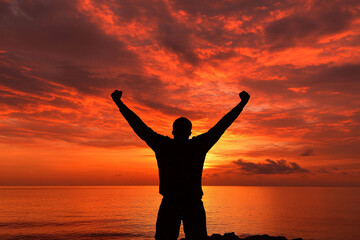 Celebrating victory at sunset with arms raised in joy