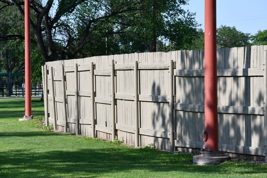 Back fence to ballfield. Stadium lights line fence line.