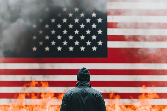 Person standing before a burning flag in a dramatic protest
