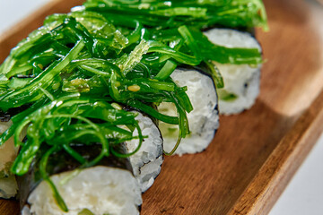 A Close-Up View of Delicious Sushi Rolls Topped with Fresh Seaweed and Garnished for an Exquisite Culinary Experience