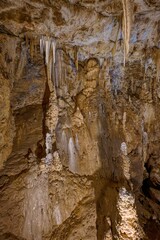 Karst formations inside Punkva Cave with illuminated stalactites and stalagmites, Moravian Karst, Czech Republic.