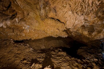 Karst formations inside Punkva Cave with illuminated stalactites and stalagmites, Moravian Karst, Czech Republic.