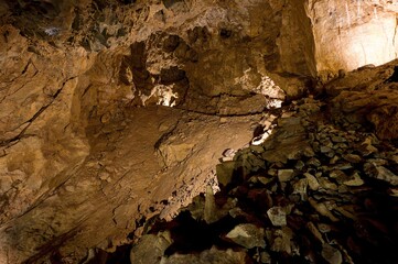 Karst formations inside Punkva Cave with illuminated stalactites and stalagmites, Moravian Karst, Czech Republic.