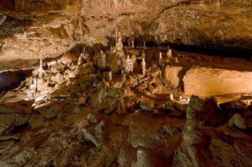 Karst formations inside Punkva Cave with illuminated stalactites and stalagmites, Moravian Karst, Czech Republic.