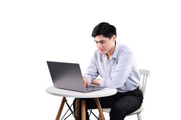 Focused Workflow: A focused individual diligently works on a laptop at a table, embodying concentration and modern productivity.