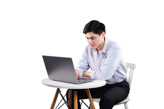 Focused Workflow: A focused individual diligently works on a laptop at a table, embodying concentration and modern productivity.