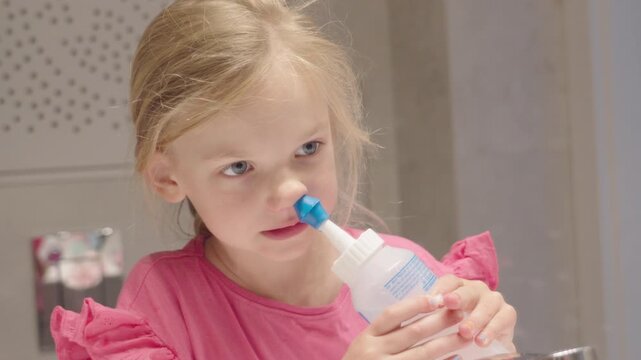 6-year-old girl using saline rinse to ease breathing problems caused by environmental pollution and chronic sinus issues.