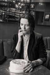 Smiling woman holding a birthday cake with a sparkler