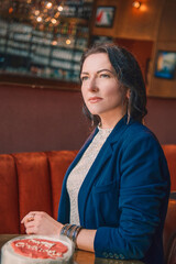 Smiling woman holding a birthday cake with a sparkler