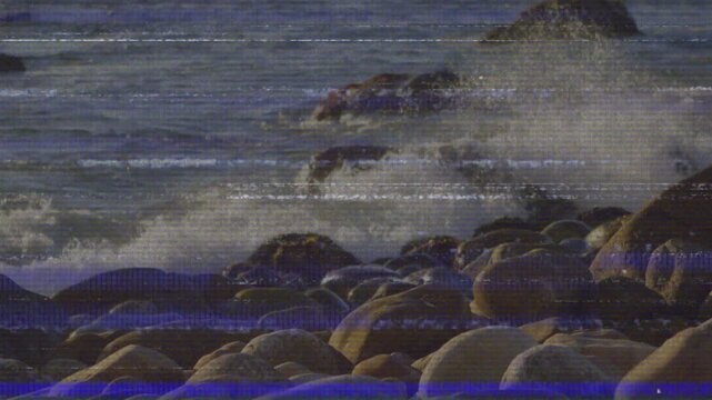 Swell rising driving waves crashing at outcrop, spraying foam over boulders in rhythmic cycle