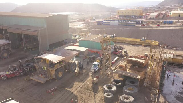 Maintenance of Mining Trucks in Truck Shop &ndash; Mechanics Working on Extraction Vehicles in Northern Chile

