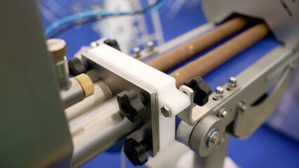 Industrial machine conveyor detail showing rollers and moving components