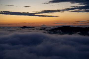 Fototapeta premium blue hour over the clouds or fog of tuscany in a view from Montepulciano into the going light of the day
