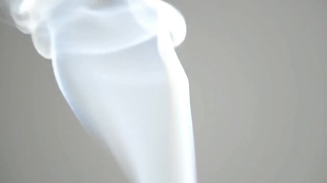 Semi-transparent soft smoke drifting upward on white backdrop.